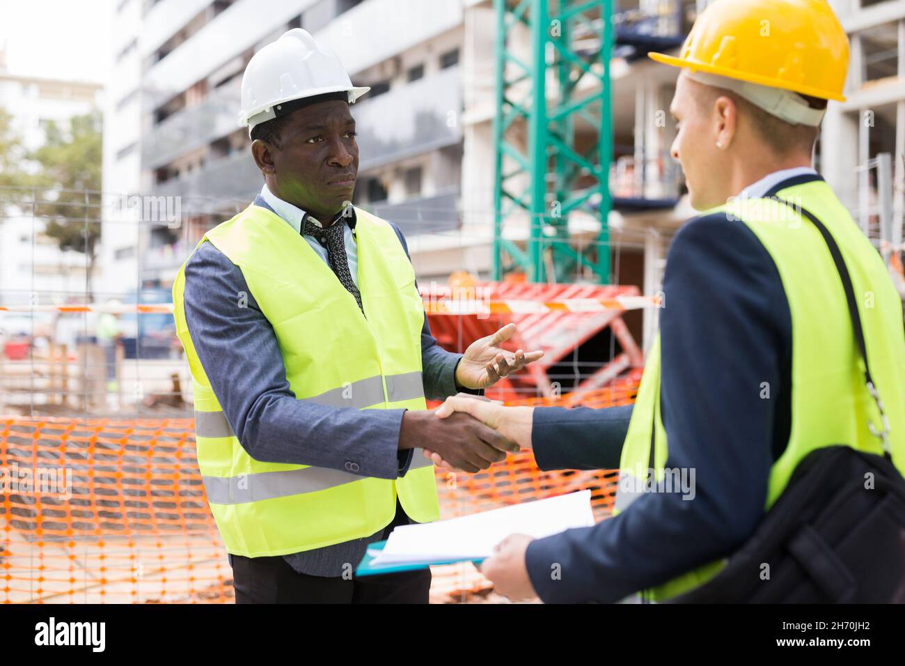 Architect and engineer construction workers shaking hands while working  Stock Photo