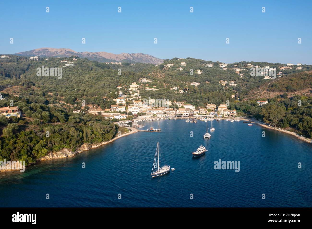 Aerial view of Agios Stefanos - a seafront fishing village, and popular tourist destination, on the northeast coast of Corfu, Ionian Islands, Greece Stock Photo