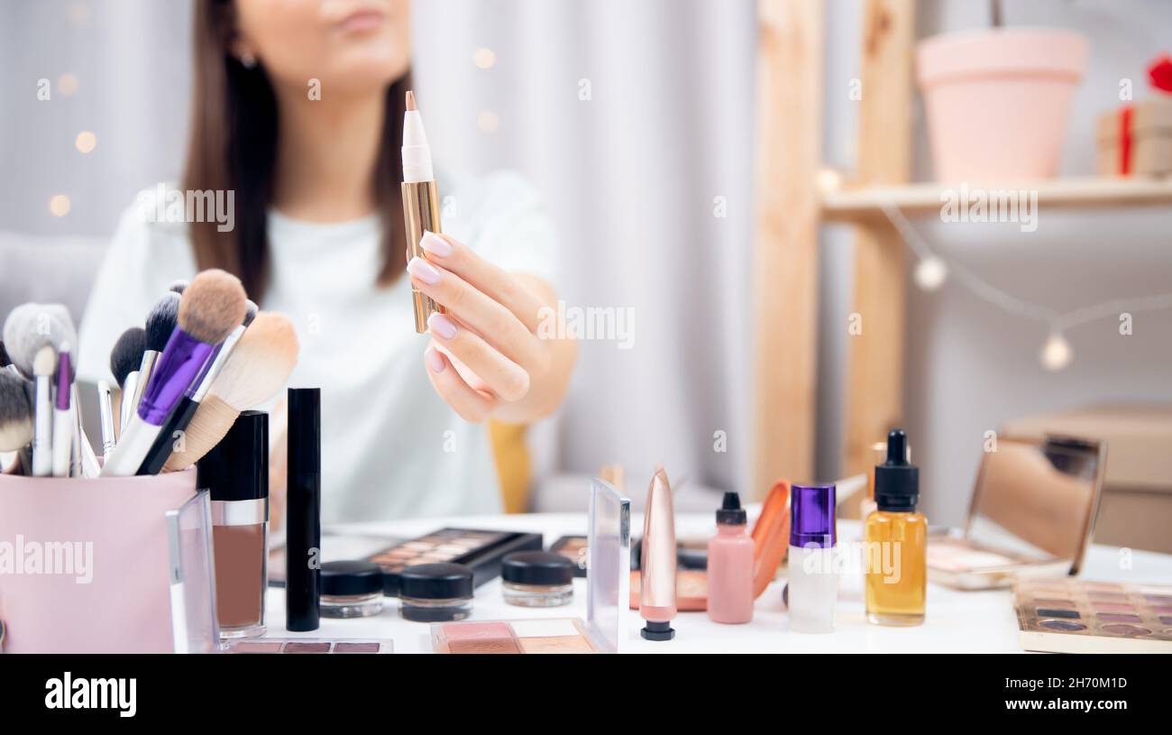Happy woman beauty blogger choice of concealer and skin tone makeup tutorial  Stock Photo - Alamy
