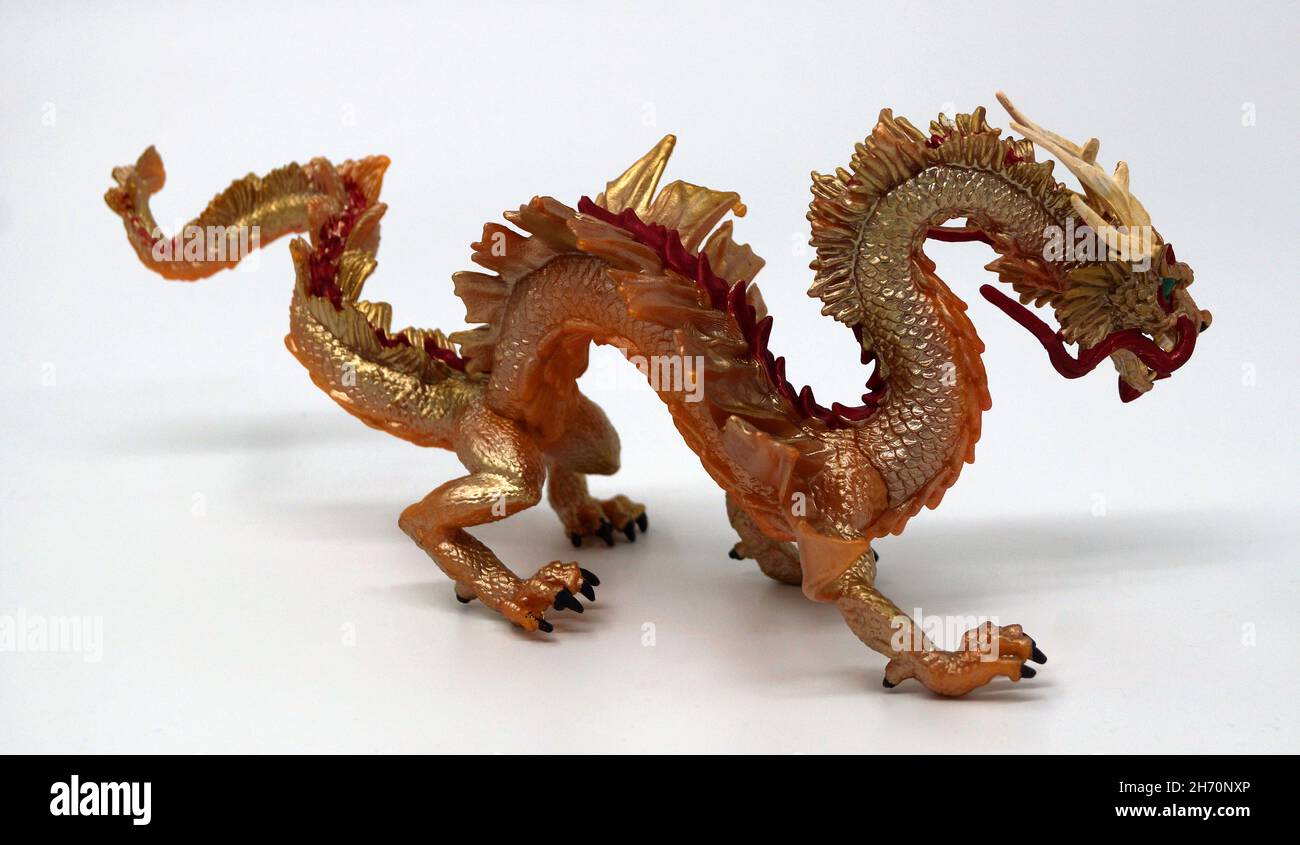 Golden dragon isolated on white. The Chinese dragon, also known as loong, long or lung, is a legendary creature. A symbol of power, strength, luck Stock Photo