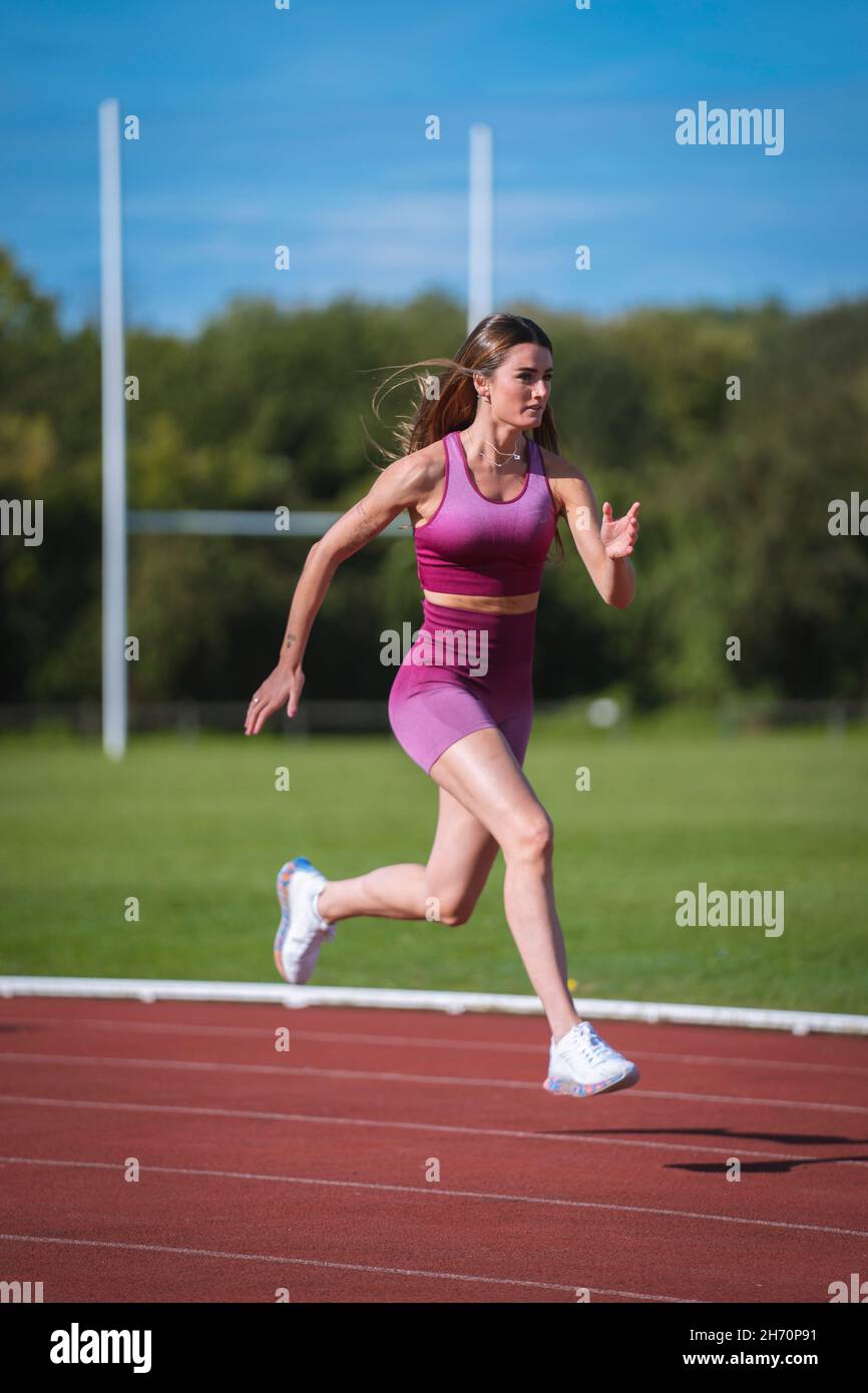 woman running on a running track Stock Photo - Alamy