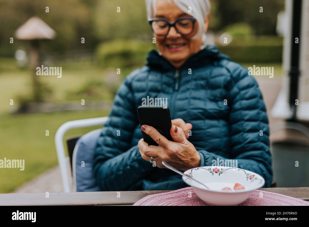 Smiling woman using phone Stock Photo