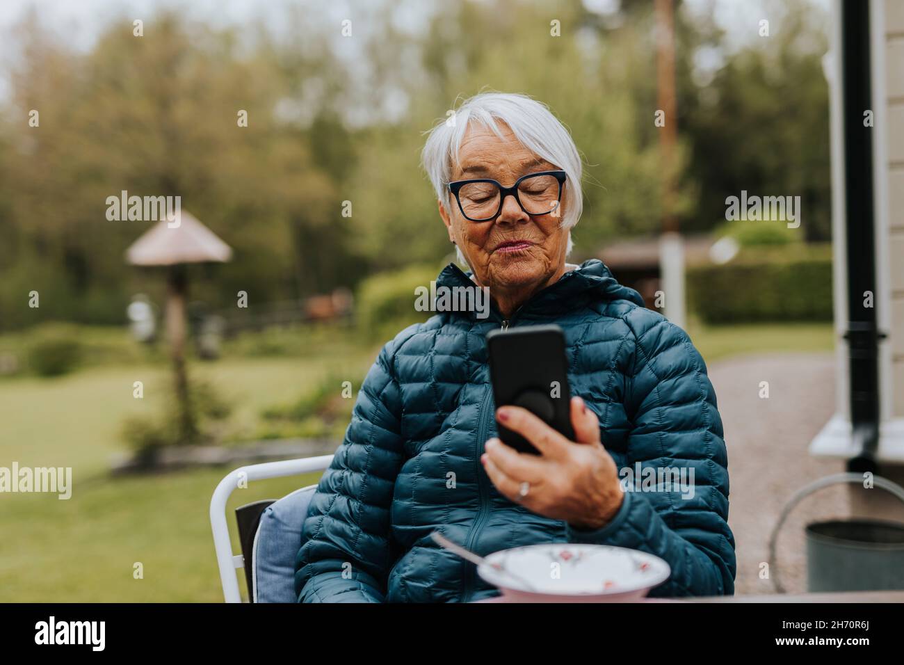 Smiling woman using phone Stock Photo