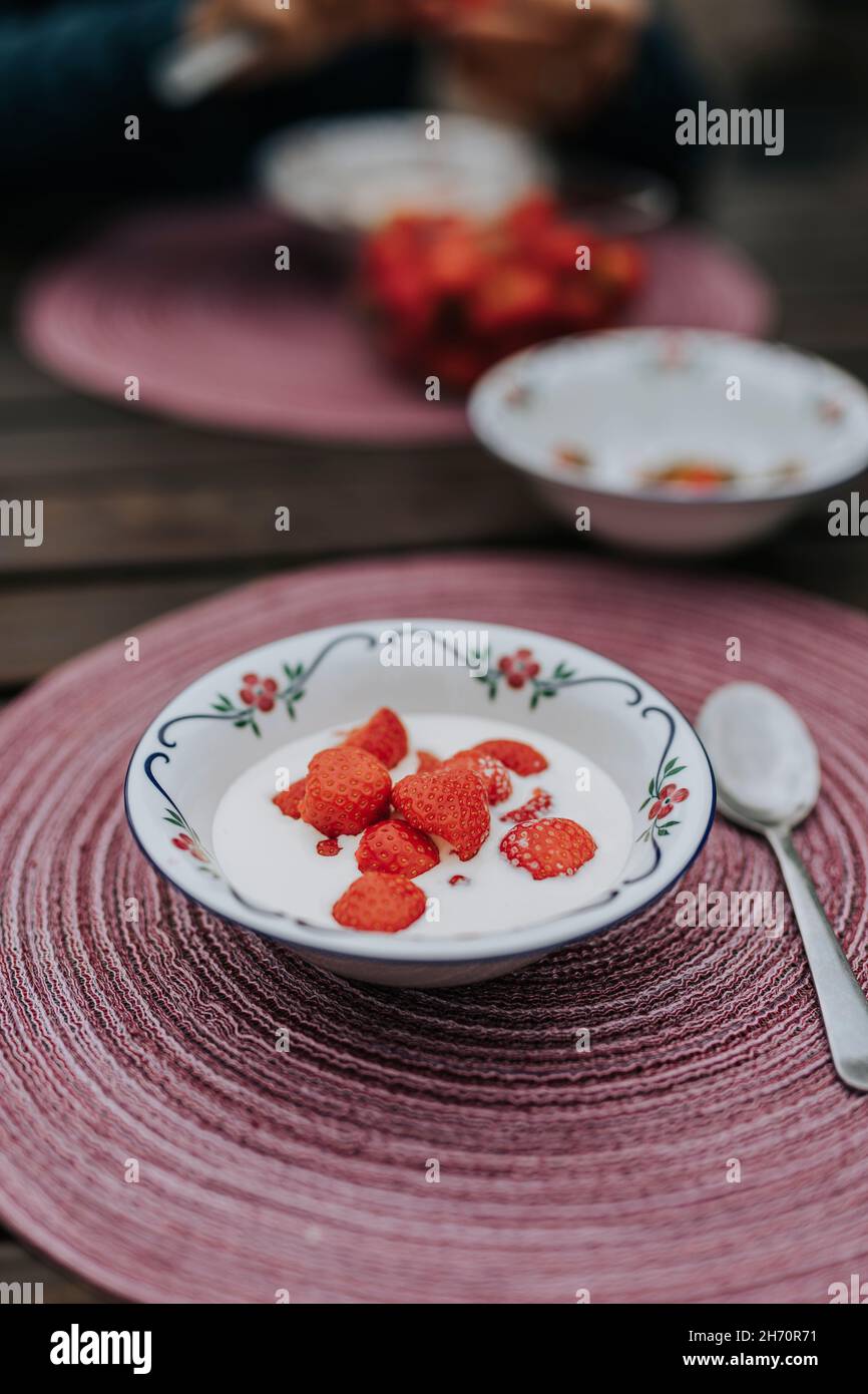 Yogurt with strawberries in bowl Stock Photo