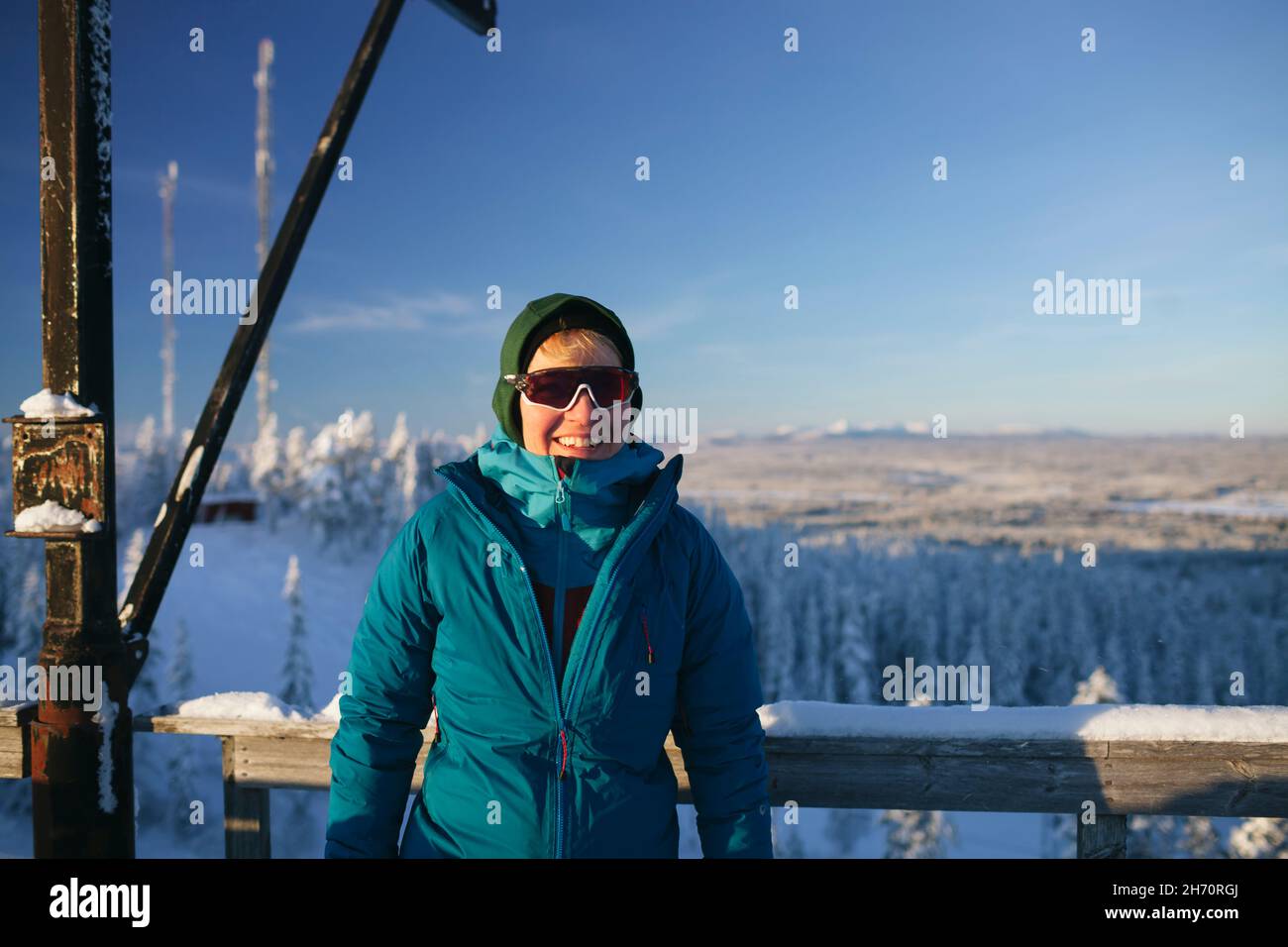 Portrait of smiling woman against winter landscape Stock Photo
