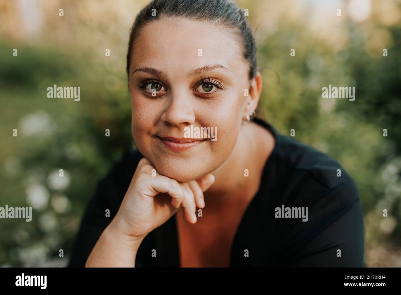 Portrait of smiling young woman Stock Photo