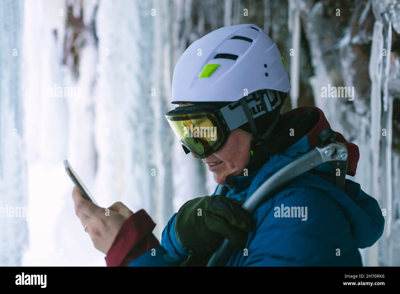 Female ice climber using cell phone Stock Photo - Alamy