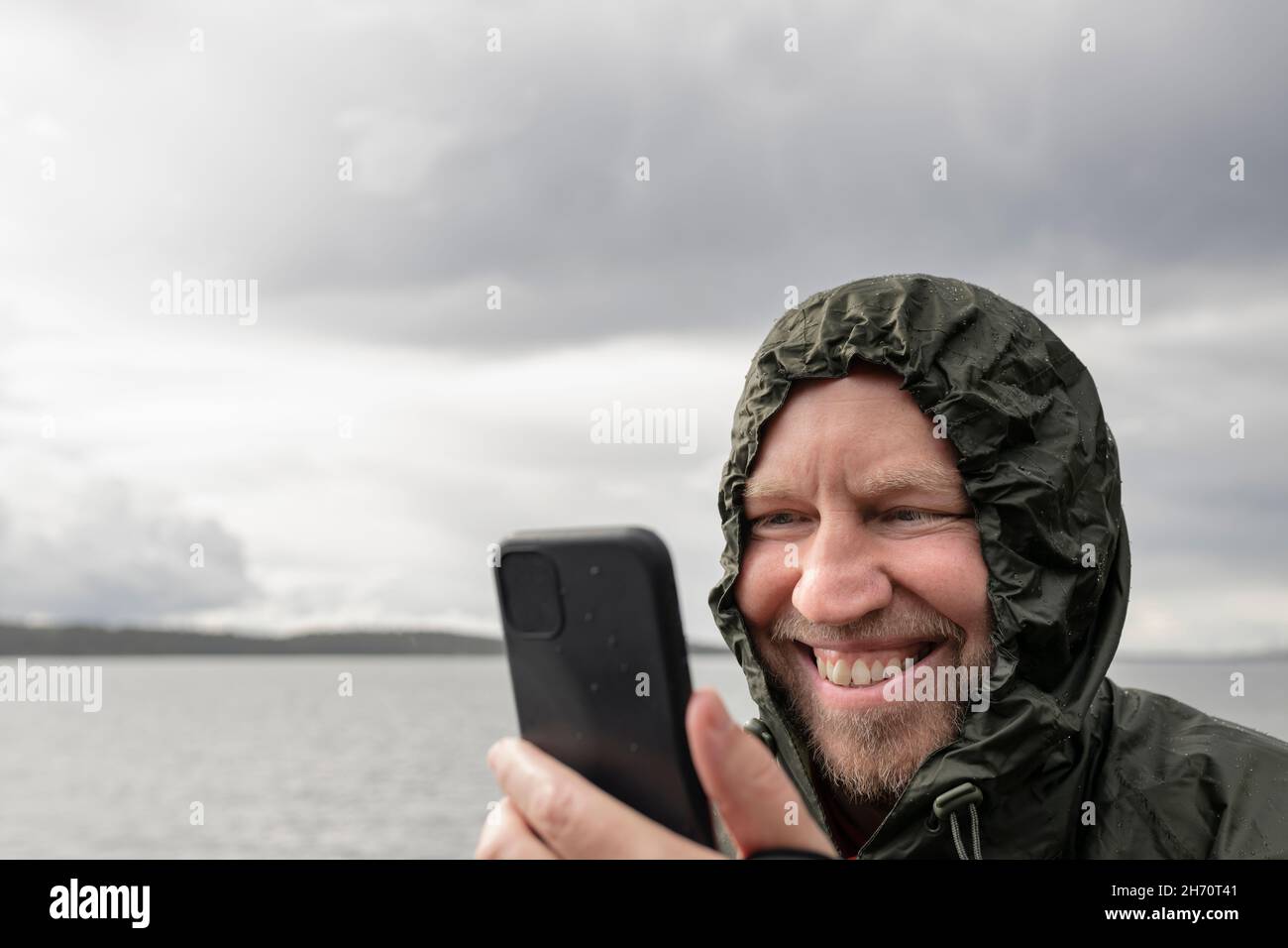 Smiling man using cell phone Stock Photo