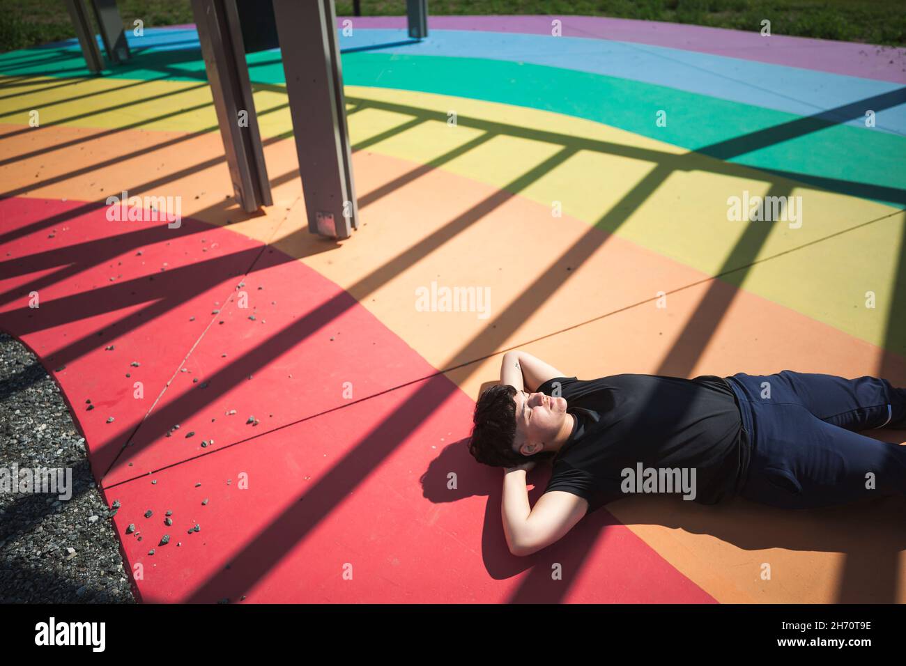 Young woman lying on colorful ground Stock Photo