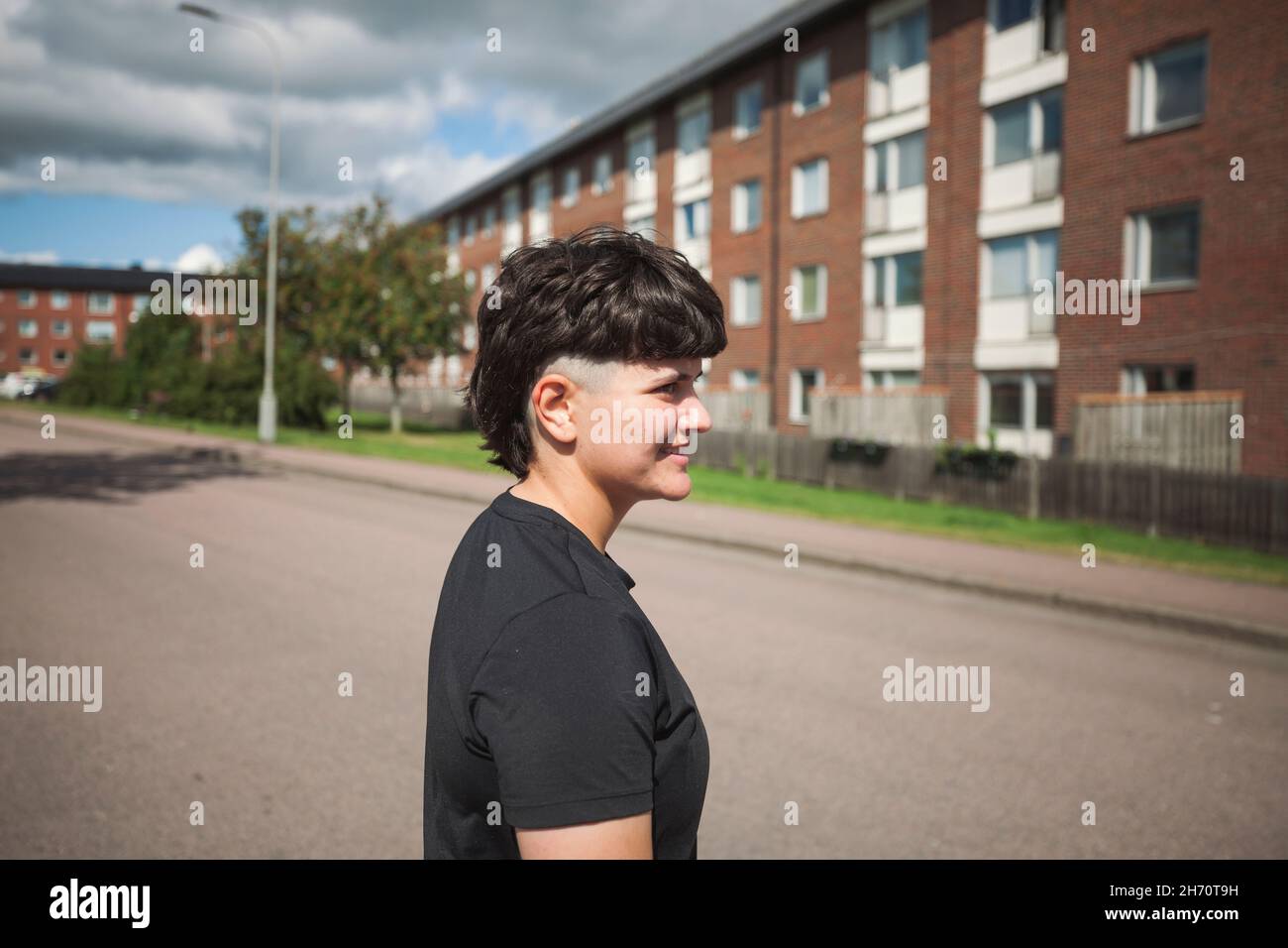 Young woman in residential district Stock Photo