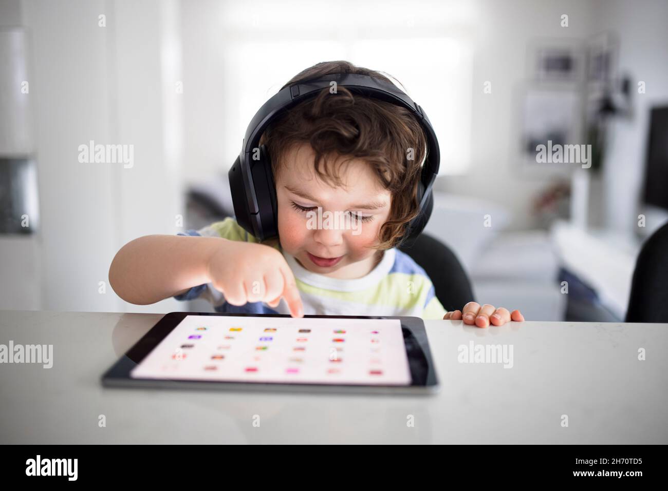 Boy in headphones using digital tablet Stock Photo