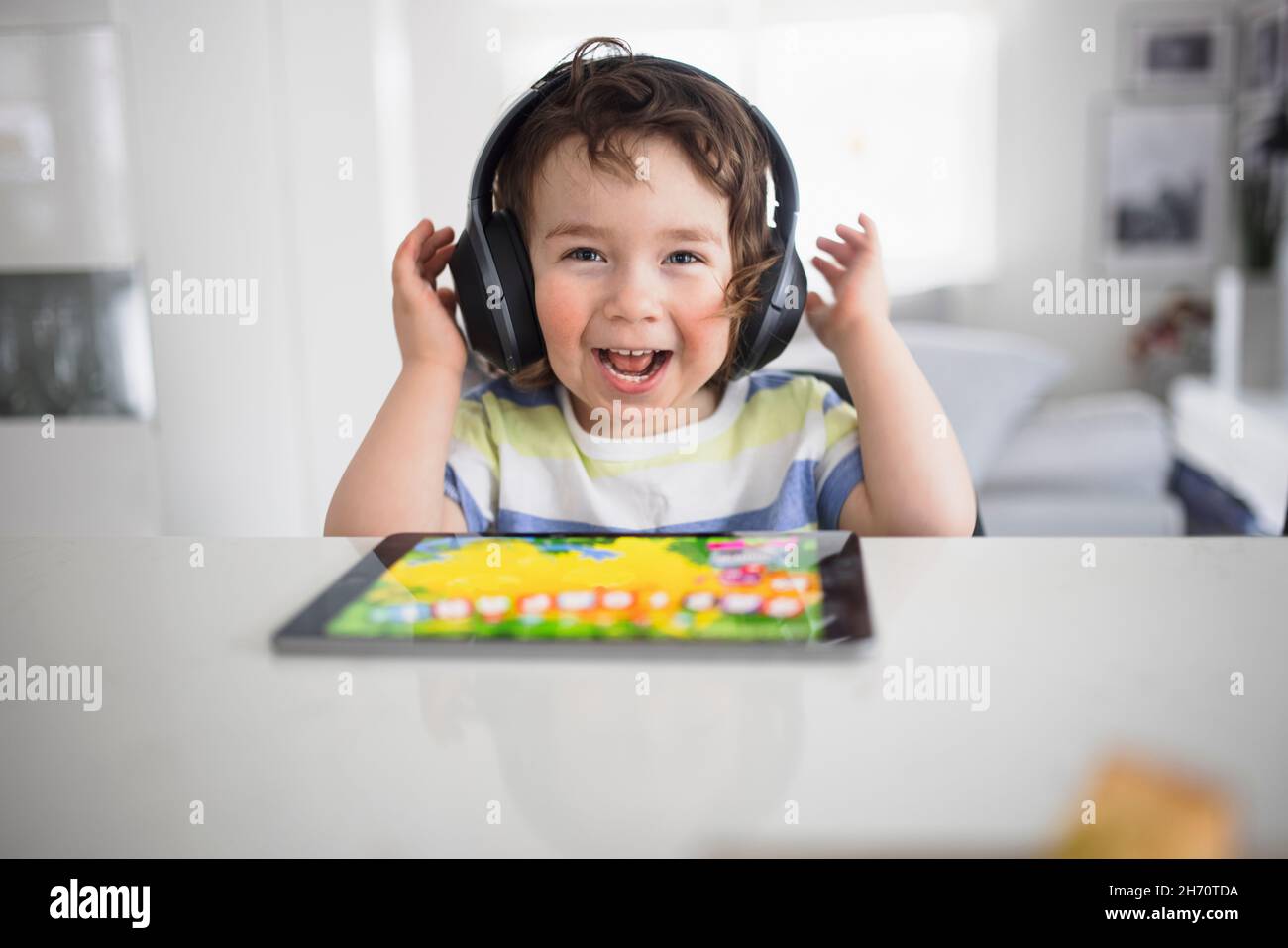 Boy in headphones using digital tablet Stock Photo