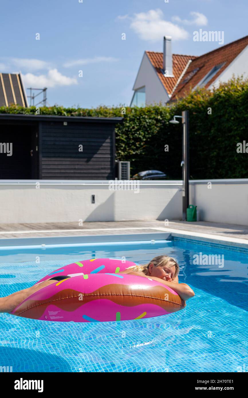 Giant Red And White Pool Floaty by Stocksy Contributor Lexia