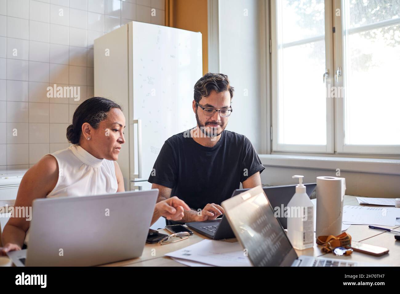 Woman and man using laptops Stock Photo