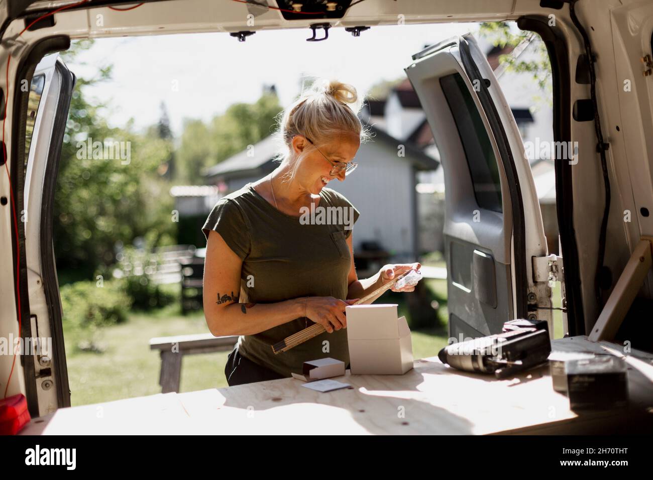 Smiling woman using tools Stock Photo