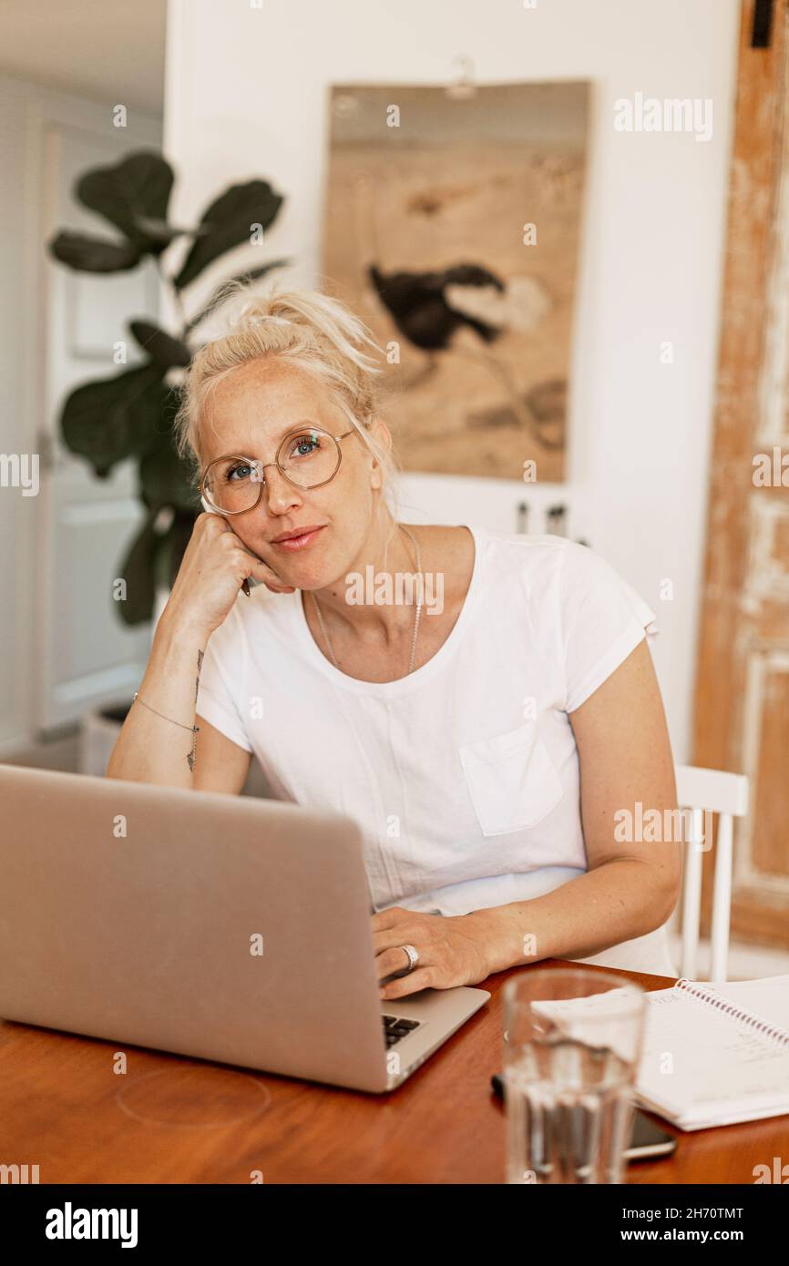 Woman using laptop at home Stock Photo