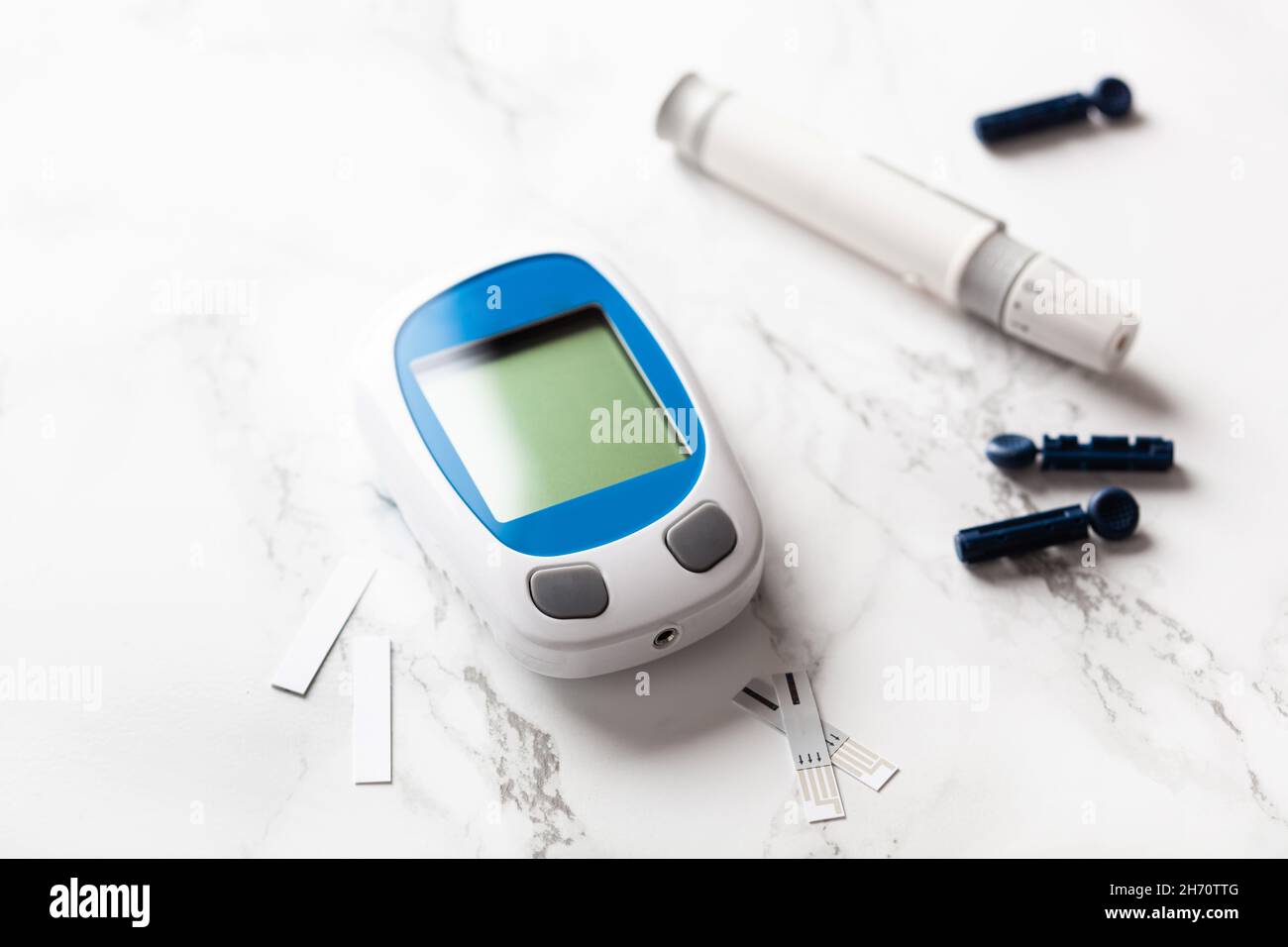 glucometer ketometer lancet and strips for self-monitoring of blood glucose or ketones level. diabetes or keto diet Stock Photo
