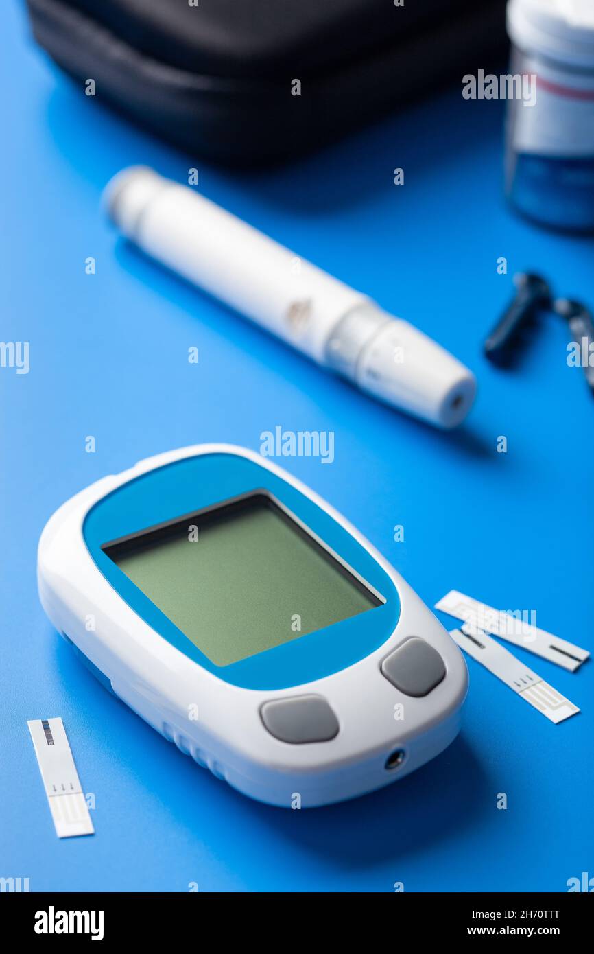 glucometer ketometer lancet and strips for self-monitoring of blood glucose or ketones level. diabetes or keto diet Stock Photo