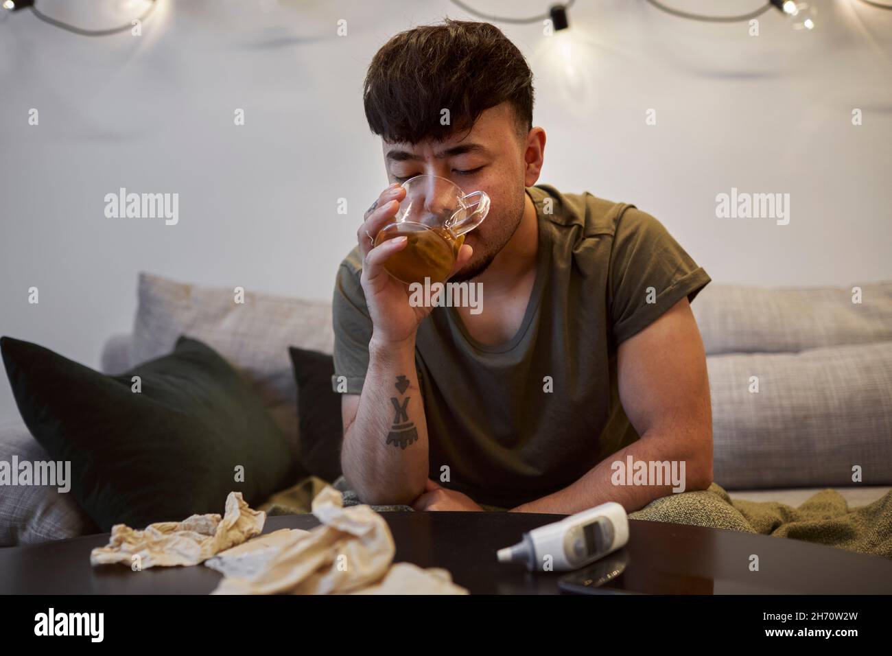 Man sitting on sofa Stock Photo
