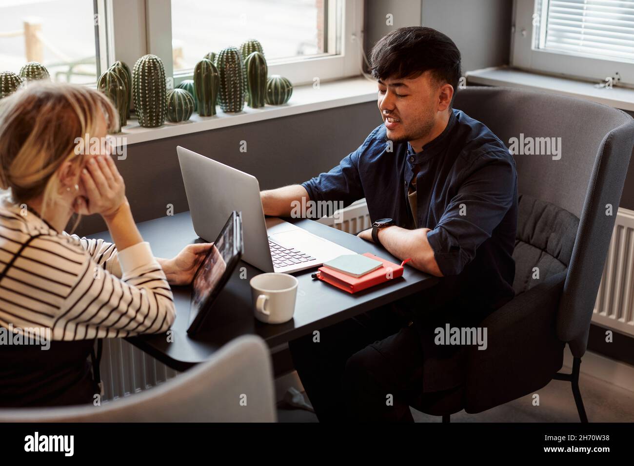 Coworkers talking in office Stock Photo