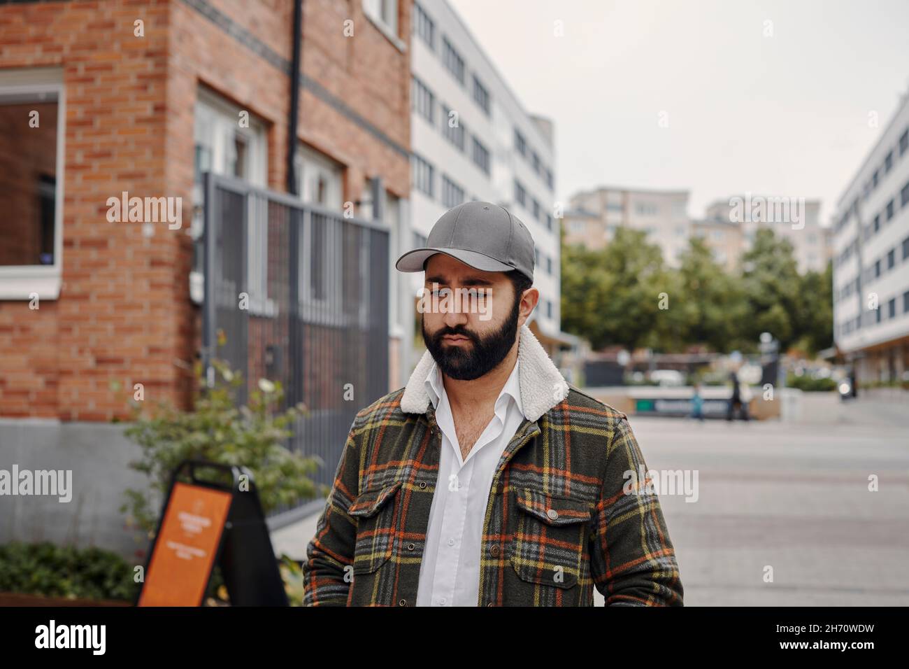 Young man walking through city Stock Photo
