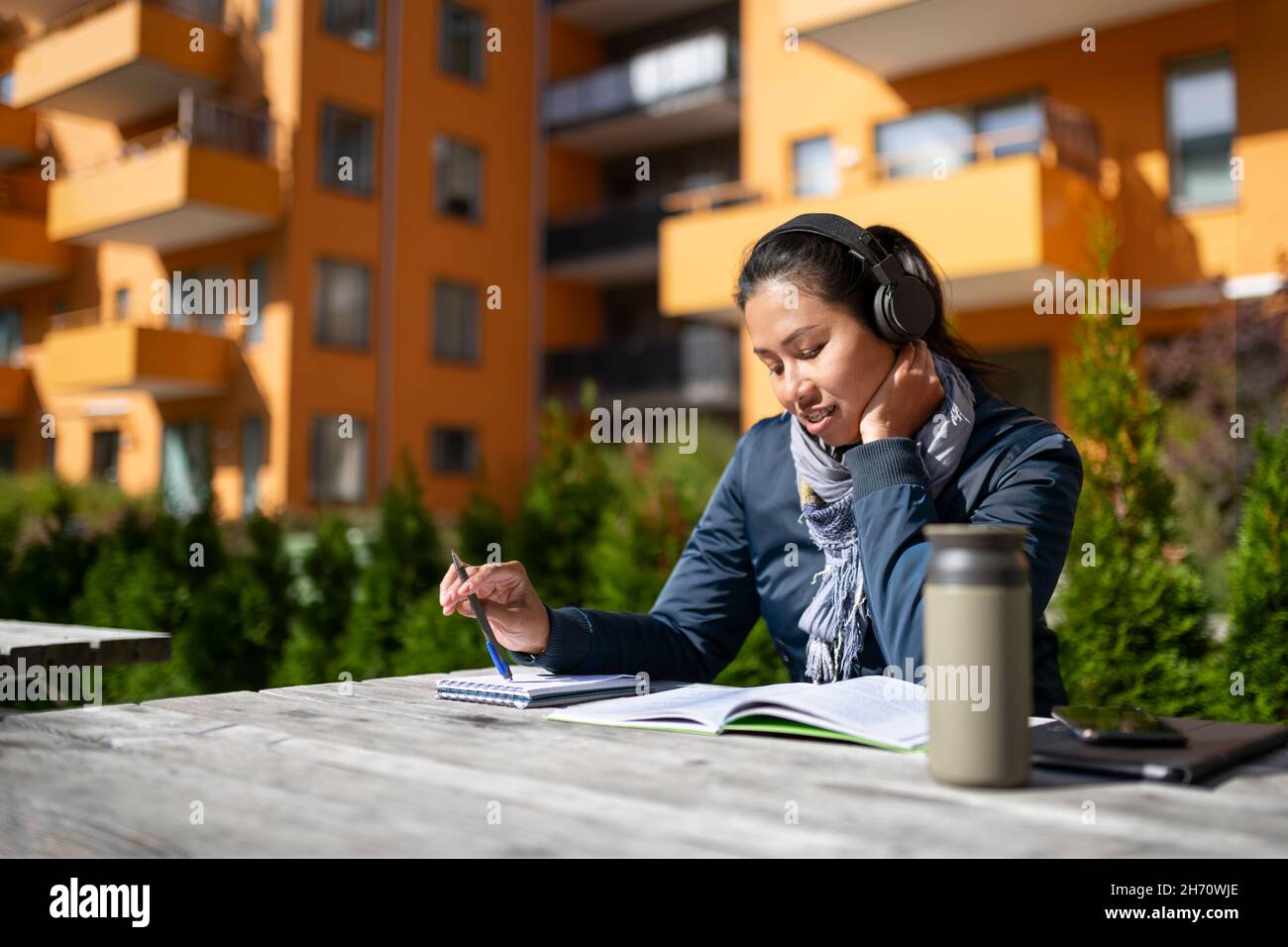 Young woman learning at courtyard Stock Photo