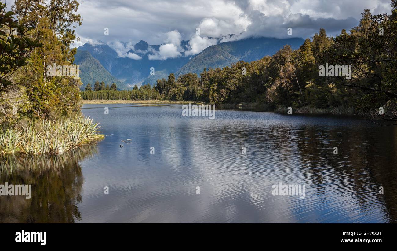 Scenic view of Lake Matheson in New Zealand in summertime Stock Photo ...