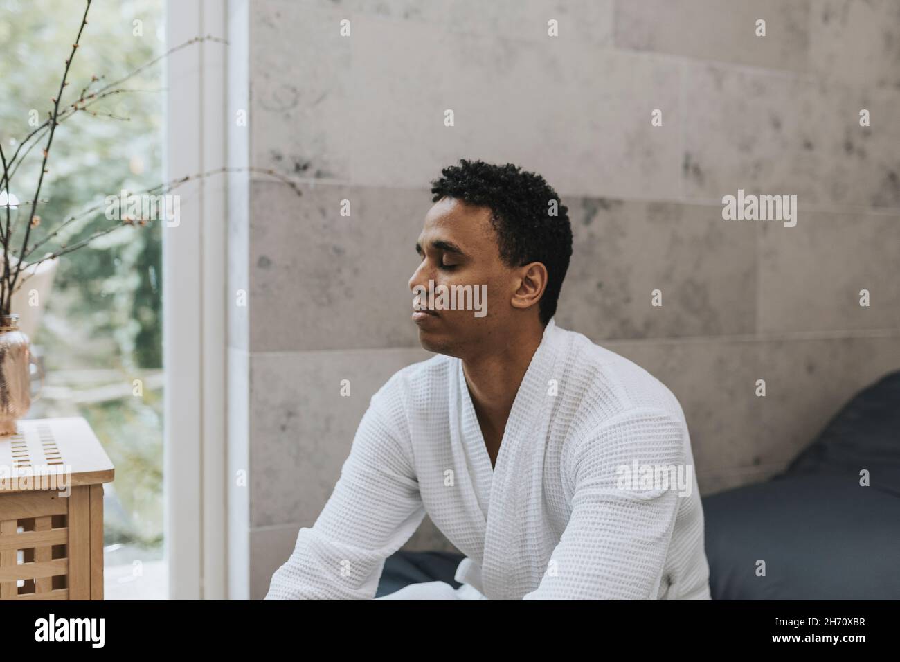 Man sitting with his eyes closed Stock Photo