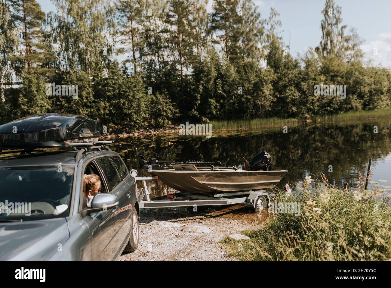 Car with boat on trailer Stock Photo - Alamy