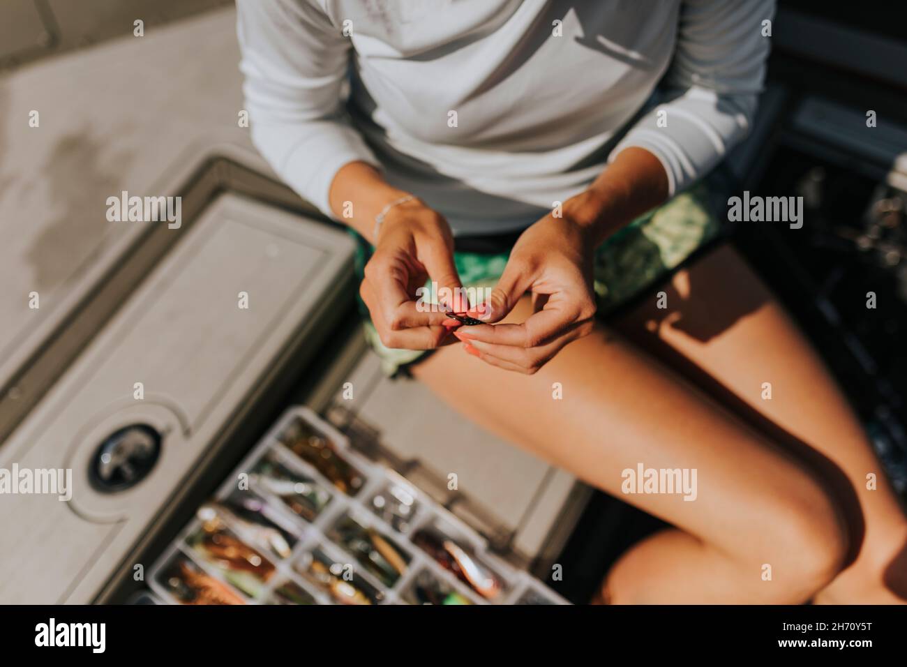Woman's hand preparing fishing bait Stock Photo