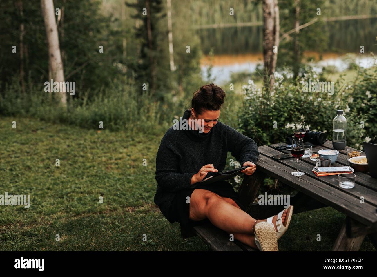 Woman using digital tablet in garden Stock Photo