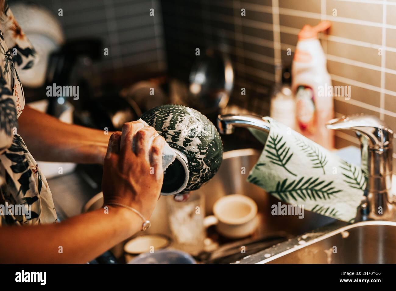 Woman's hands washing dishes Stock Photo