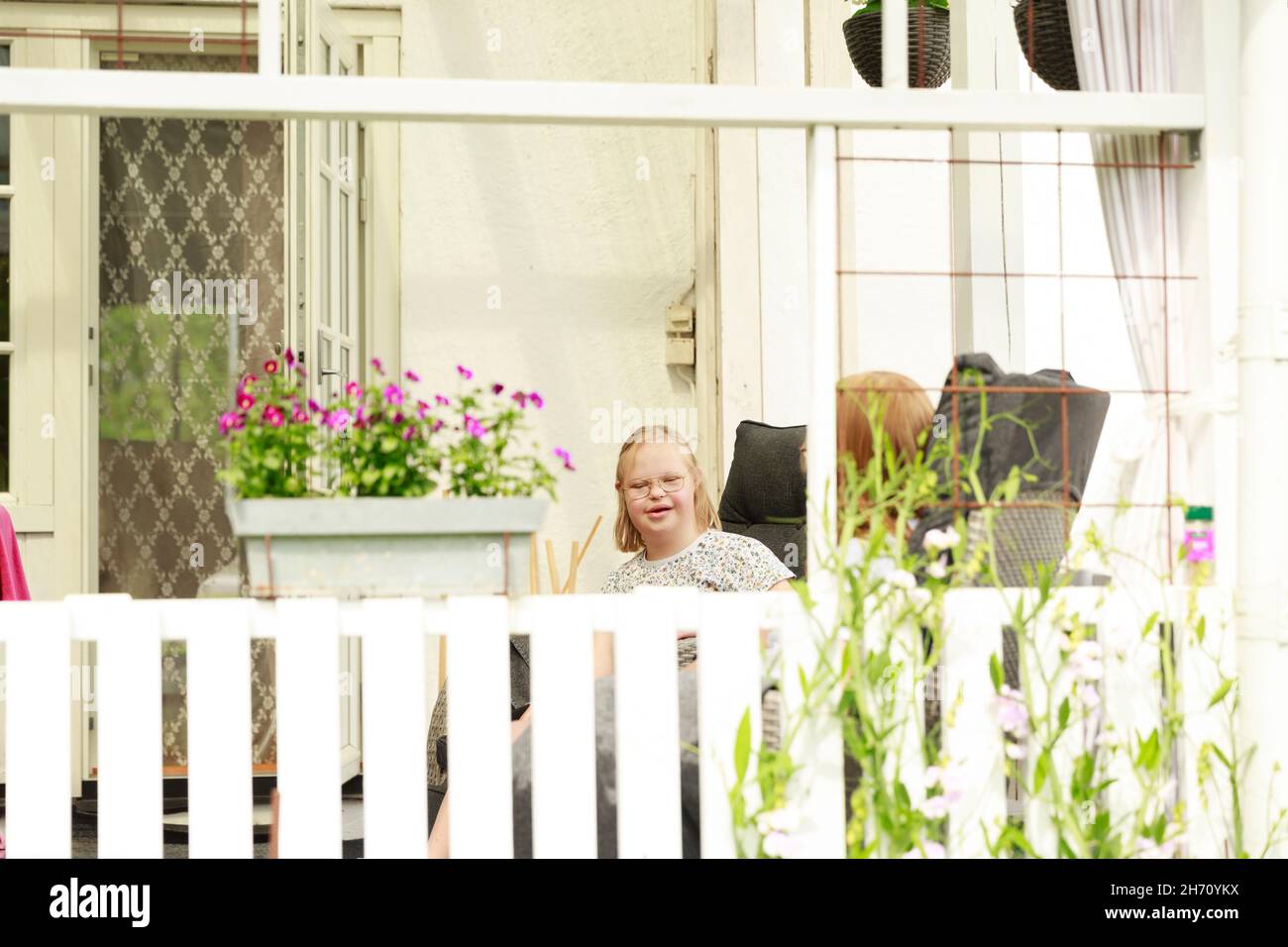 Girl sitting on porch in summer Stock Photo - Alamy