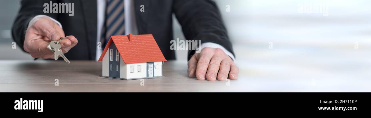 Real estate agent holding house keys, concept of home ownership Stock ...