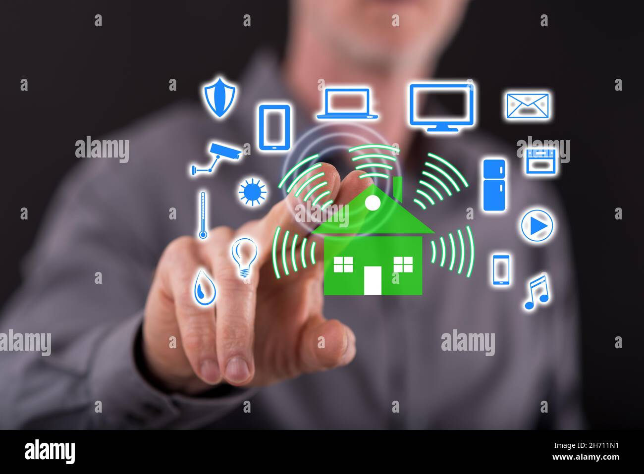 Man touching a smart home concept on a touch screen with his finger ...