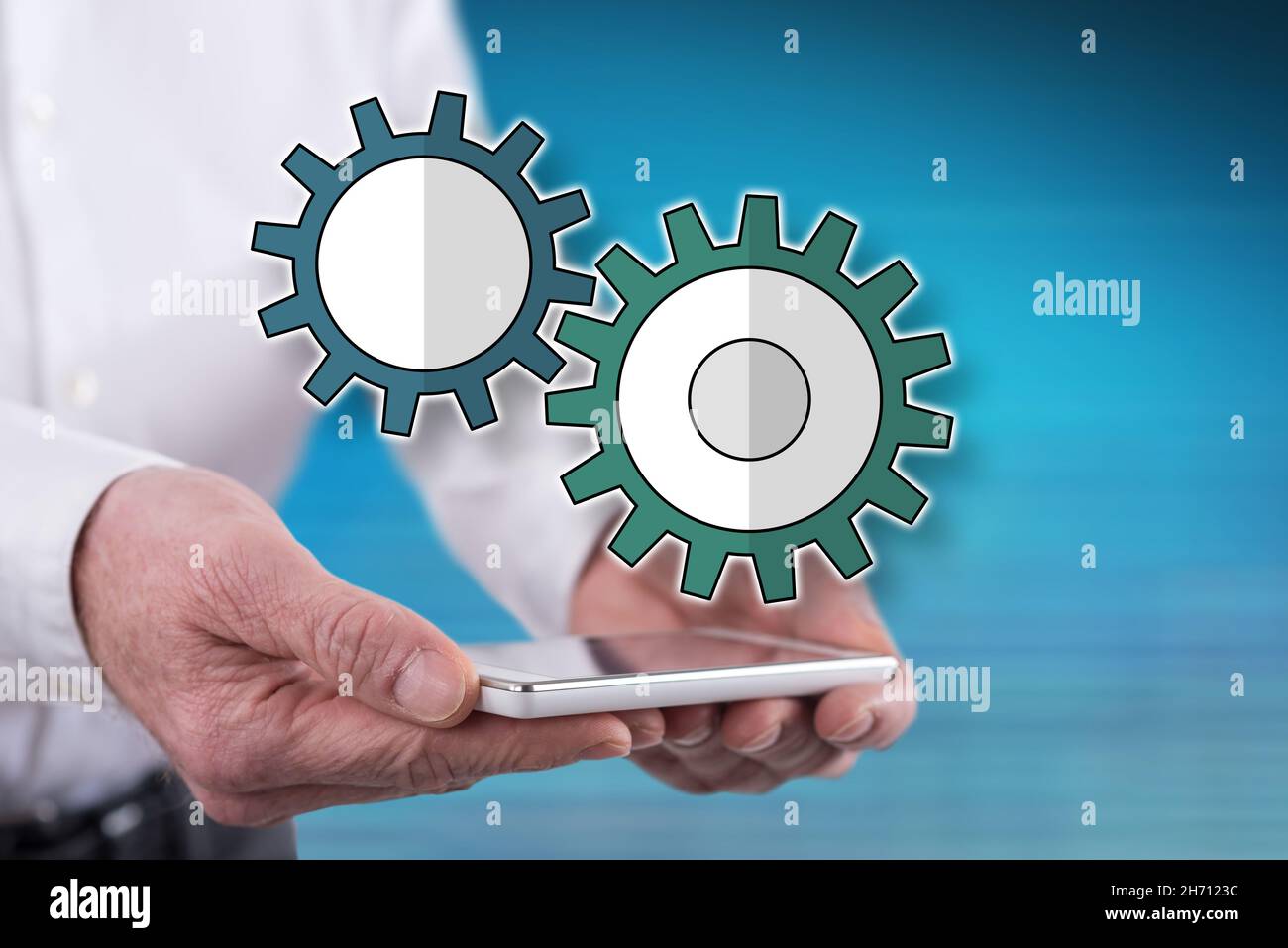 Setting concept above a smartphone held by hands Stock Photo