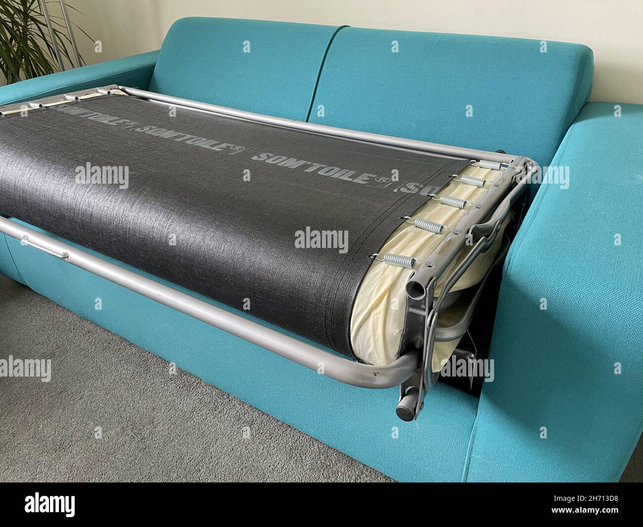 Closeup shot of a folding blue couch in the house Stock Photo