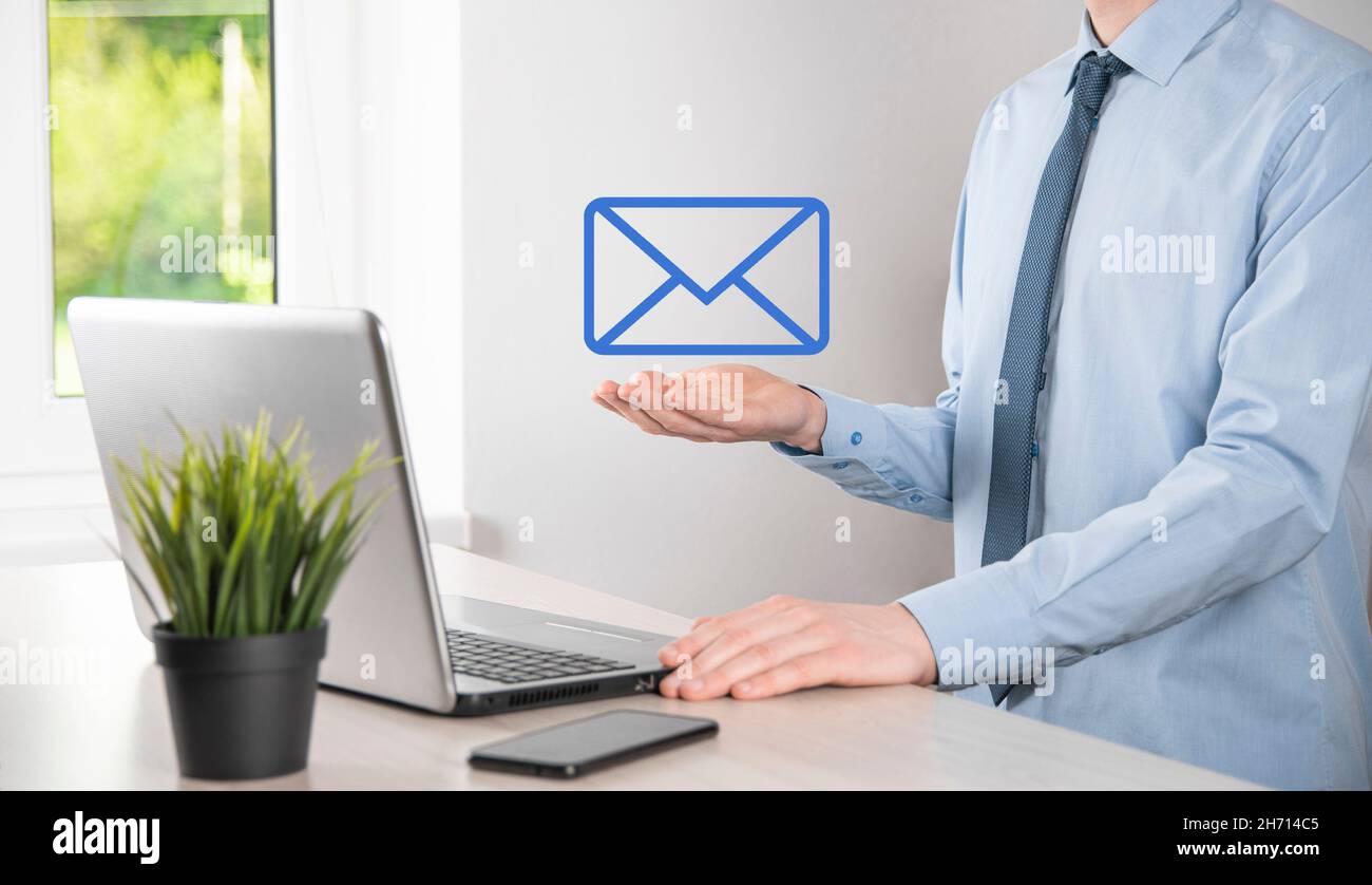 Businessman hand holding e-mail icon, Contact us by newsletter email ...