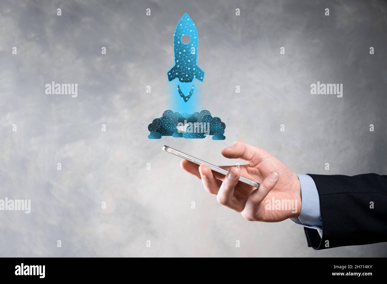 Startup business concept, Businessman holding in hand icon rocket is ...