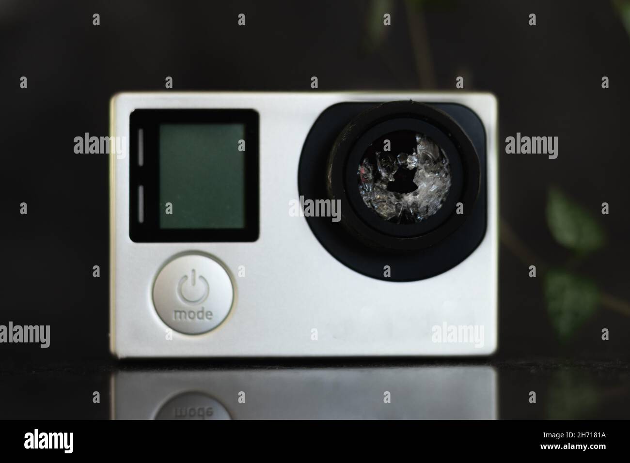 Closeup shot of a white broken action camera on a glassy table Stock Photo