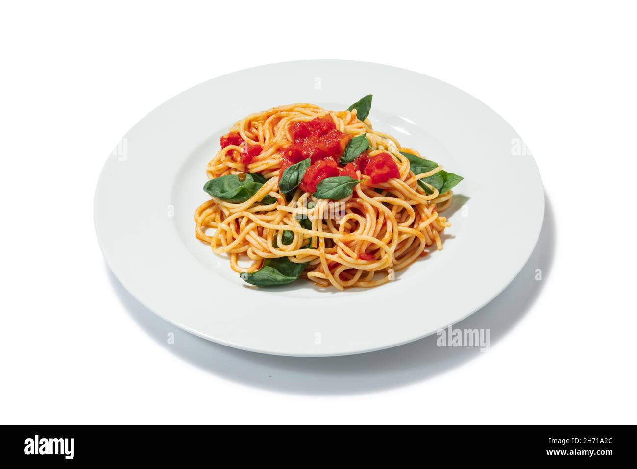 Italian food. Plate with delicious pasta with tomatoes and basil leaves ...