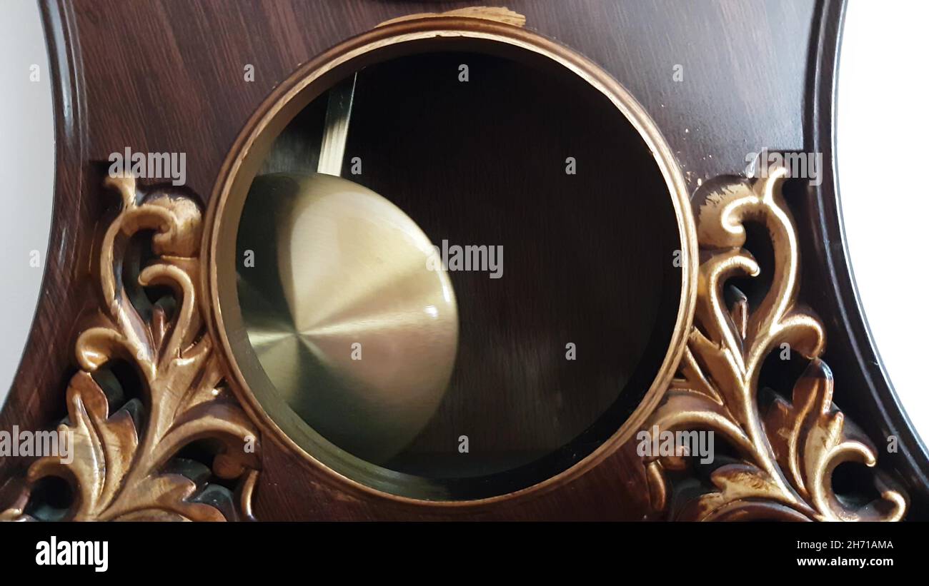 pendulum clock ticking here and there closeup Stock Photo Alamy