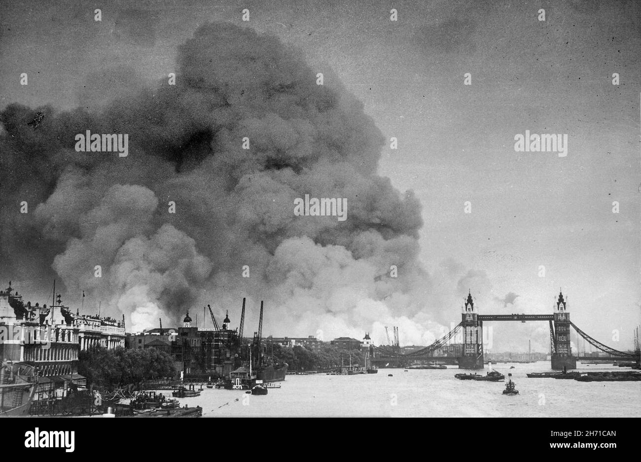 LONDON, ENGLAND, UK - 07 September 1940 - View along the River Thames in London towards smoke rising from the London docks after an air raid during th Stock Photo