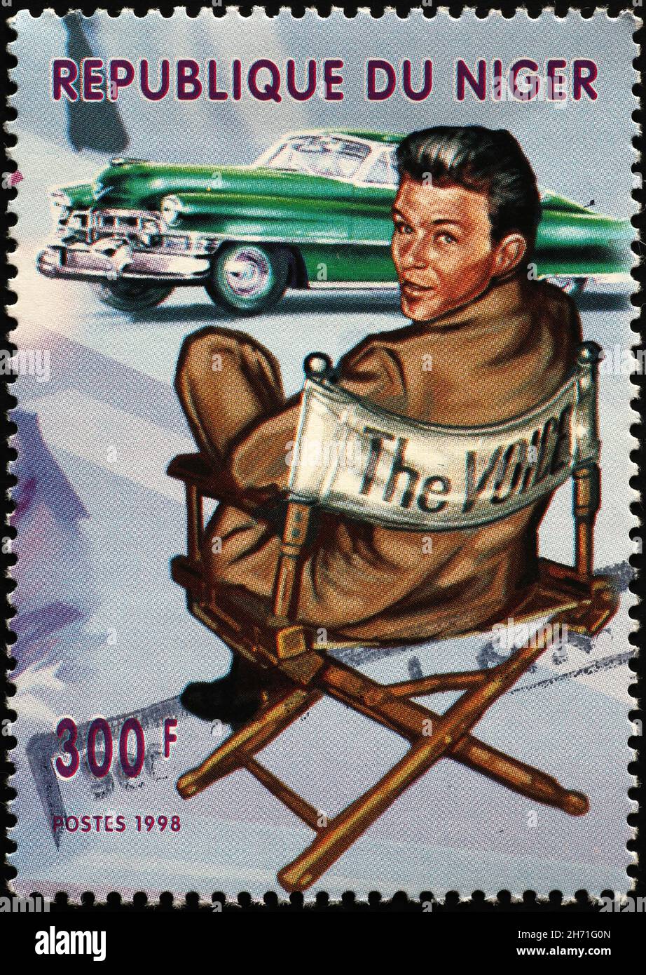 Frank Sinatra and vintage car on postage stamp Stock Photo