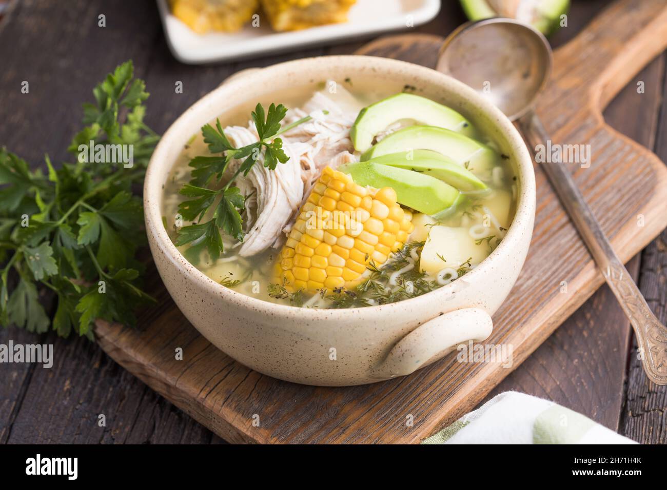 Traditional Ajiaco Colombiano - Colombian Soup with potato, chicken, avocado Stock Photo