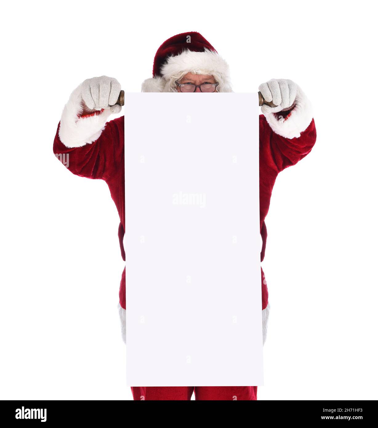 Santa Claus holding a blank scroll in front of his body. Santa is looking over the top of the long roll of paper. Stock Photo