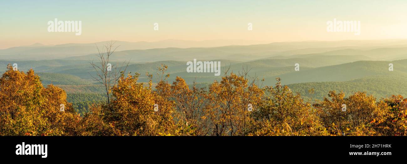 View over Ouachita National Forest from Talimena Scenic byway at sunrise on a November morning, with mist in the valleys and over the hill tops Stock Photo