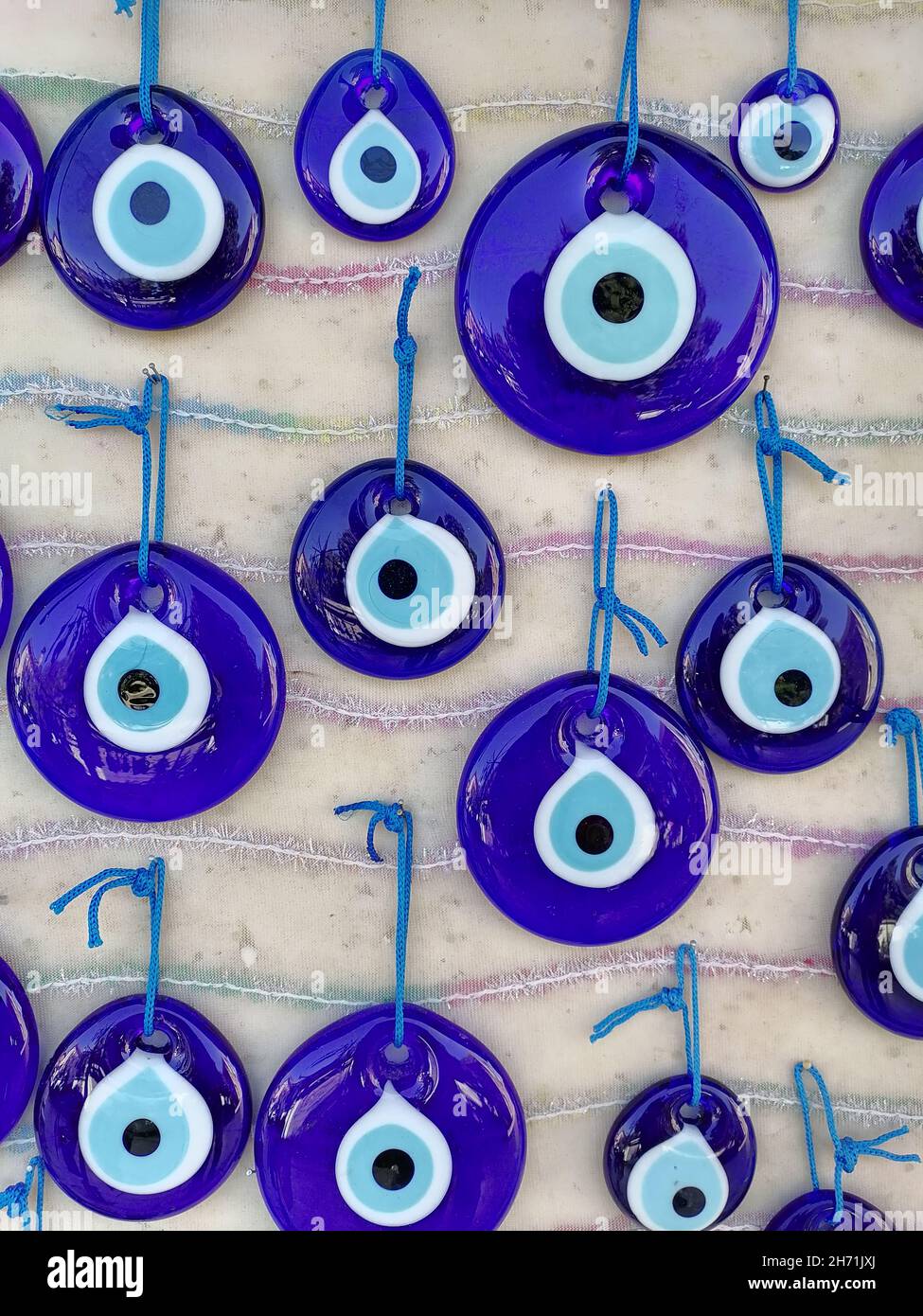 Turkish Evil Eye beads on the wall. Stock Photo