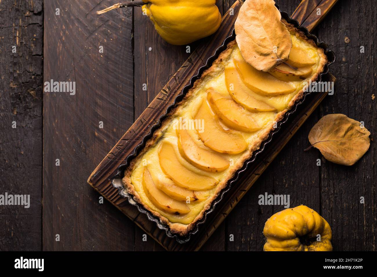 quince tart with custard open and shortcrust pastry and cinnamon. Stock Photo