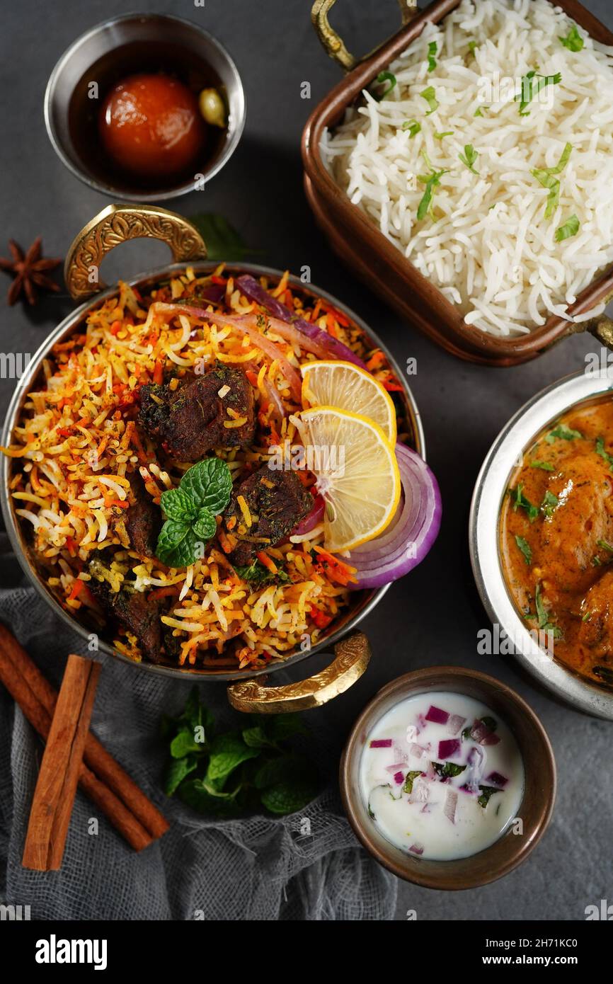 Indian veg non veg meal thali mutton biryani, raita, malai kofta